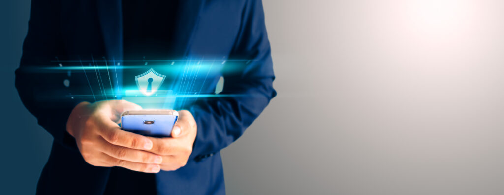 Close up business man formal blue suit Use hold smart phone in the dark. Use finger print unlock smart phone security.